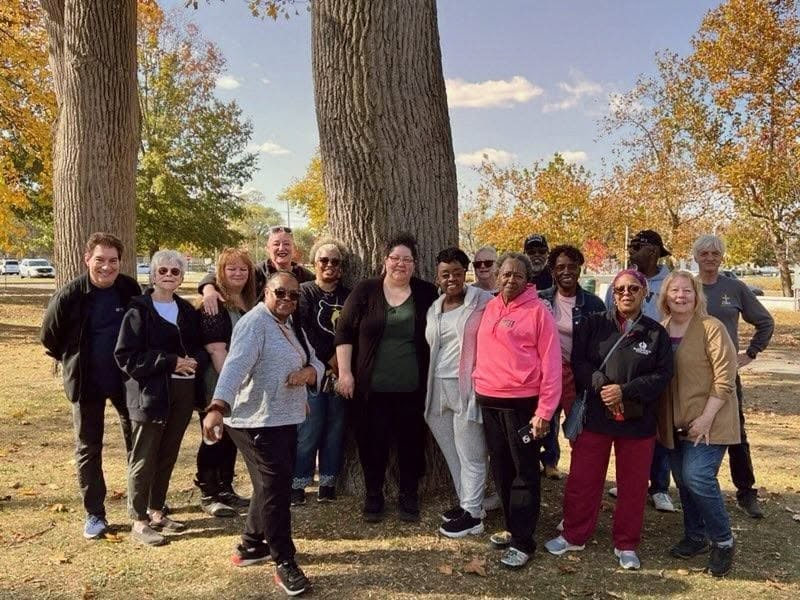 A community group gathered outdoors in autumn